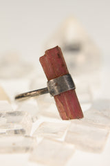 Blush Harmony Pink Tourmaline ring displayed on Clear Quartz with oxidized hammered sterling silver band.