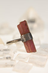 Blush Harmony Pink Tourmaline ring displayed on Clear Quartz with oxidized hammered sterling silver band.
