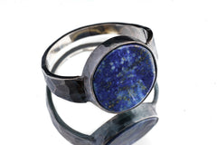 Side view of old cut Lapis Lazuli ring showing heavy oxidized sterling silver band and open-back setting.
