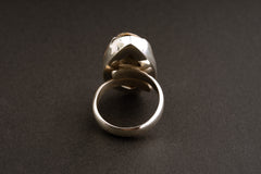 Crystalized shell ring shown from the back with cut-out sterling silver construction and adjustable band.