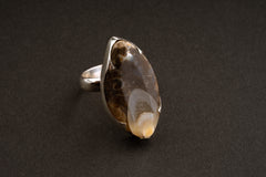 Ancient Tide crystalized shell ring side view showing waved bezel and textured sterling silver band.