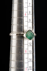 The mandrel image suggests the ring is approximately US size 5.5 to 6, but the exact size should be confirmed before publishing. The listing states Australian Raw Emerald and approx. 2 mm sterling silver band, so those details were prioritized. No more specific mine or locality was added.