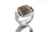 Tiger Eye brutalist ring in oxidized 925 sterling silver with rectangular golden brown stone and bark-like texture.