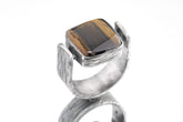 Tiger Eye brutalist ring in oxidized 925 sterling silver with rectangular golden brown stone and bark-like texture.