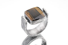 Tiger Eye brutalist ring in oxidized 925 sterling silver with rectangular golden brown stone and bark-like texture.