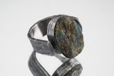 Mystic Oculus Labradorite ring in oxidized 925 sterling silver with circular flashing stone and bark-like texture.