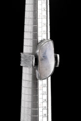 Rectangular Moonstone ring shown beside a ruler for scale, with oxidized 925 sterling silver and brutalist band profile.
