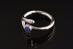 Close-up of adjustable Lightning Ridge Rainbow Opal ring showing hammered sterling silver and luminous blue stone.