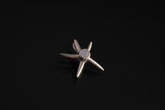 Blue Moonstone starfish charm shown hanging on black cord, with high-shine sterling silver and ocean talisman design.