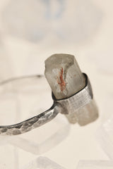 Close-up of raw Torrington Aquamarine ring showing natural crystal texture, silver wrap setting, and handmade hammered band.