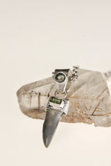 Megalodon Tooth pendant shown worn on a model, with Aquamarine cabochon, Raw Green Tourmaline, and sterling silver setting.