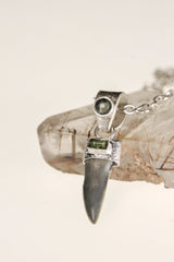 Close-up of fossil Megalodon Tooth in sand-textured sterling silver setting, showing raw ancient tooth texture.