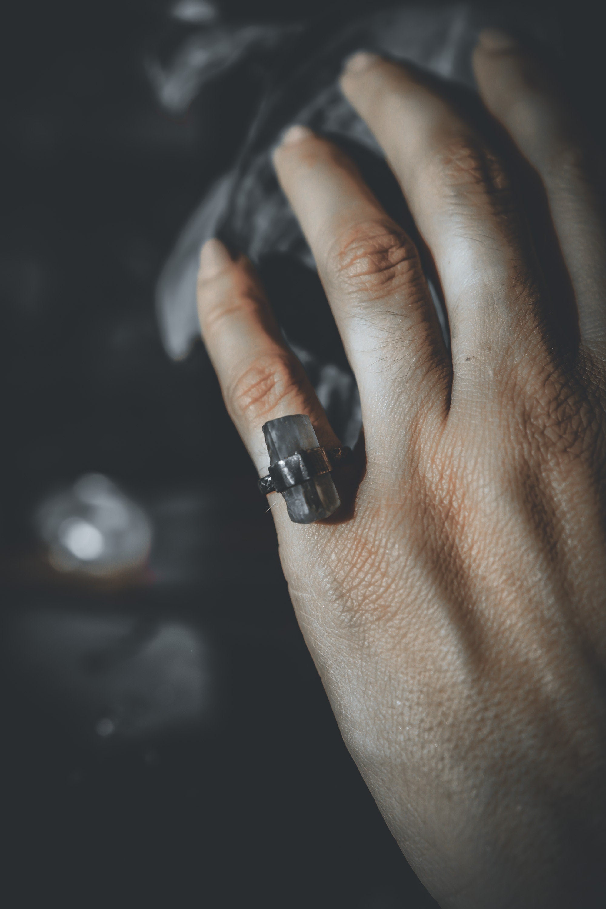 Handmade oxidized 925 sterling silver Torrington Aquamarine ring shown worn on the hand, with raw blue-green crystal.