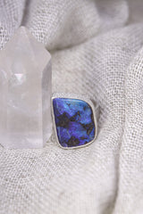 Square-cut Opal ring shown on soft fabric, with high-shine sterling silver and luminous internal colour flashes.