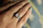 Handmade 925 sterling silver Lightning Ridge Opal ring shown worn on the hand, with pale Australian Opal and textured band.