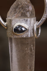 Close-up of river-tumbled Sapphire set into the front of an Australian Lemurian Quartz sterling silver halo pendant.