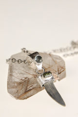 Megalodon Tooth Aquamarine Green Tourmaline pendant on white background with sterling silver chain and rugged fossil form.