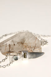 Megalodon Tooth Aquamarine Green Tourmaline pendant shown hanging on a model, with sand-textured sterling silver and ocean fossil design.