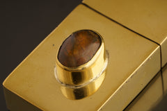 Close-up of Ethiopian Opal brass keepsake box showing raised Opal setting and smooth polished brass lid.