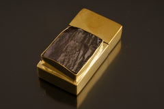 Close-up of Amethyst brass matchbox showing elevated bezel setting, tight lid, and polished golden surface.