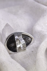 Side view of adjustable fossil ring showing the high-shine sterling silver band, waved bezel, and open ring construction.