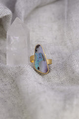 Gold-plated Opal ring shown on soft fabric, with waved bezel setting and warm 18k gold-plated sterling silver band.