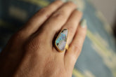 Opal gold-plated adjustable ring shown worn on the hand, with 18k gold over sterling silver and luminous colour play.