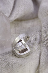 Back view of square Opal adjustable ring showing open sterling silver band and cut-out support plate beneath the setting.