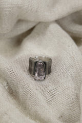 Vera Cruz Amethyst ring shown on soft fabric, with oxidized sterling silver and delicate purple crystal centrepiece.