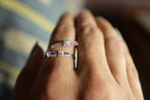 Amethyst Embrace Ring shown worn on hand with two Vera Cruz Amethyst stones and polished sterling silver band.