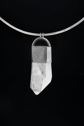 Clear Quartz Halo pendant shown on black cord, with polished 925 sterling silver frame and large transparent crystal point.