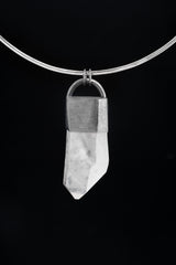 Clear Quartz Halo pendant shown on black cord, with polished 925 sterling silver frame and large transparent crystal point.