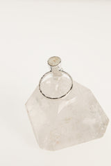 Back view of raw Aquamarine ring showing the circular sterling silver band and handmade crystal setting.