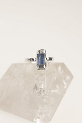 Australian Ocean Kyanite sterling silver ring displayed on clear quartz, with oxidized handmade setting and blue mineral stone.