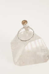 Back view of natural Amber sterling silver ring showing the circular band shape and raised fossil resin setting.