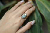 Raw Australian Aquamarine ring shown worn on a hand, with oxidized hammered sterling silver and pale blue crystal.