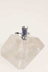 Oxidized sterling silver Ocean Kyanite ring shown on quartz, with hammered handmade band and deep blue stone.