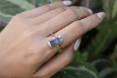 Handmade oxidized 925 sterling silver Australian Ocean Kyanite ring shown worn on the hand, with deep blue stone and hammered band.