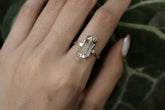 Handmade oxidized 925 sterling silver raw Australian Aquamarine ring shown worn on the hand, with a pale blue crystal stone.