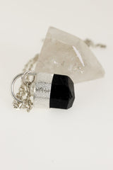 Close-up of Black Tourmaline pendant showing sand-textured sterling silver setting and small Herkimer Diamond accent.