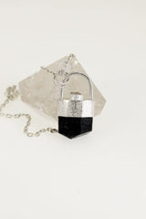 Black Tourmaline Herkimer Diamond pendant on white background with 925 sterling silver cap and compact crystal setting.
