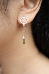 Green Tourmaline chain earrings shown worn on the ear, with round hammered silver studs and delicate raw crystal dangles.
