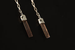 Pink Tourmaline chain stud earrings shown on a dark background, with hammered round silver tops and delicate dangle chains.