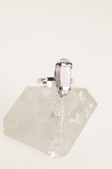 Vera Cruz Amethyst ring displayed on clear quartz, showing oxidized silver band and double terminated crystal setting.