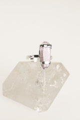 Vera Cruz Amethyst ring displayed on clear quartz, showing oxidized silver band and double terminated crystal setting.