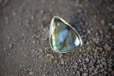 Triangular Labradorite adjustable ring in high-shine 925 sterling silver shown close-up with blue-green flash.