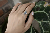 Handmade oxidized 925 sterling silver Australian Ocean Kyanite ring shown worn on the hand, with deep blue crystal and hammered band.