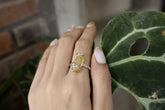 Handmade 925 sterling silver Amber fossil ring shown worn on the hand, with warm honey-gold stone and textured silver band.