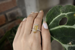 Handmade 925 sterling silver Amber fossil ring shown worn on the hand, with warm honey-gold stone and textured silver band.