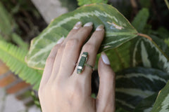 Handmade oxidized 925 sterling silver Australian Jade ring shown worn on the hand, with deep green stone and hammered band.